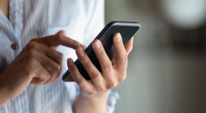 person dialing on phone