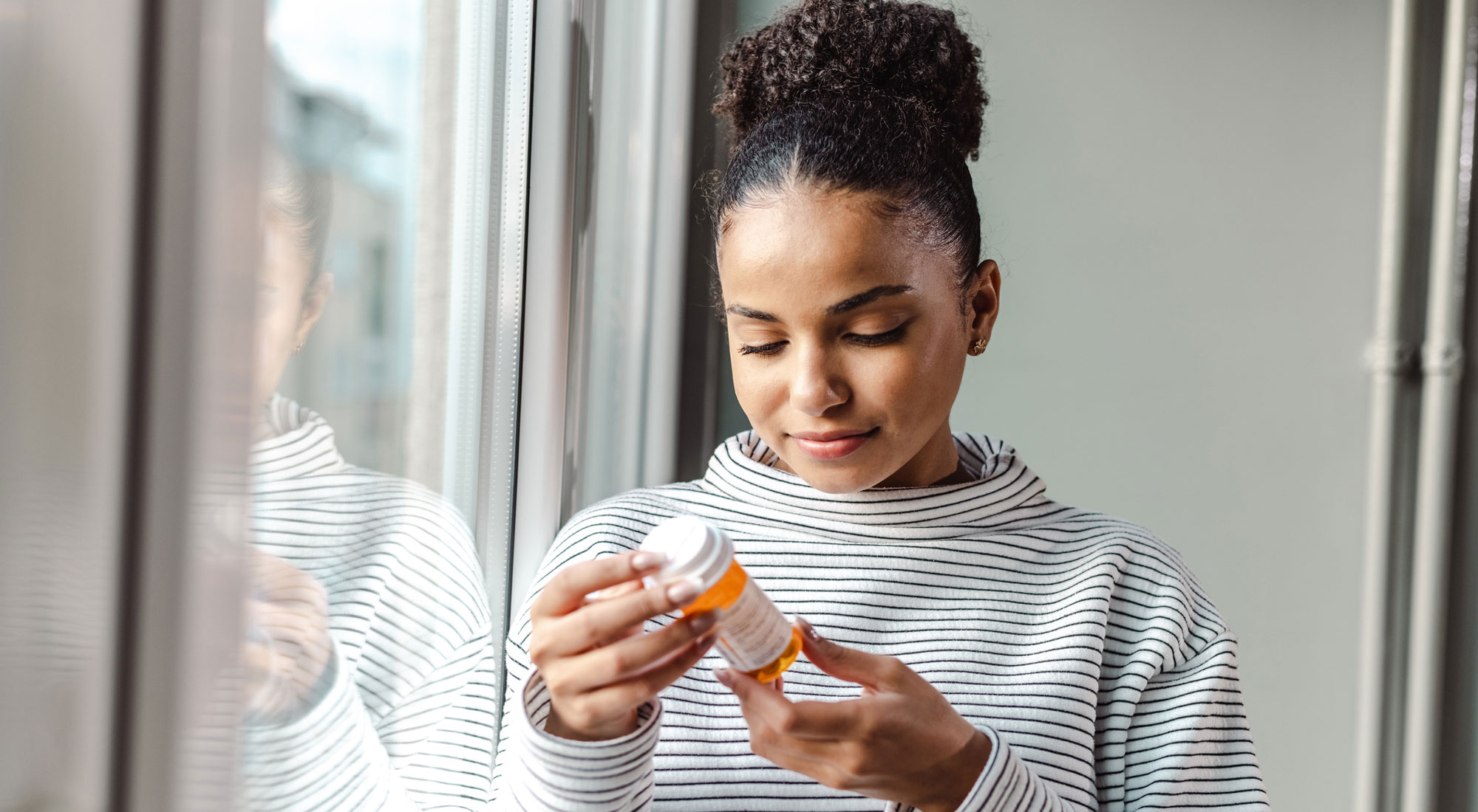 woman holding anti-depressants